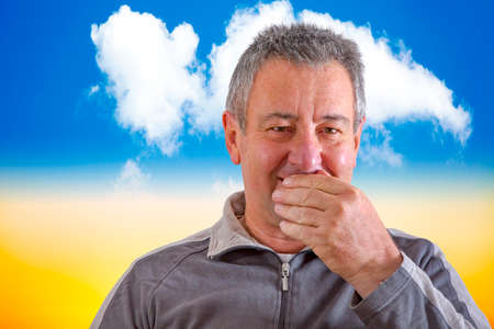 Man with hand in front of mouthの写真素材