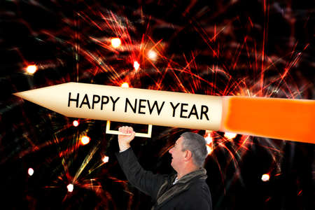 Man with big New Year's Eve rocket at the turn of the year.
