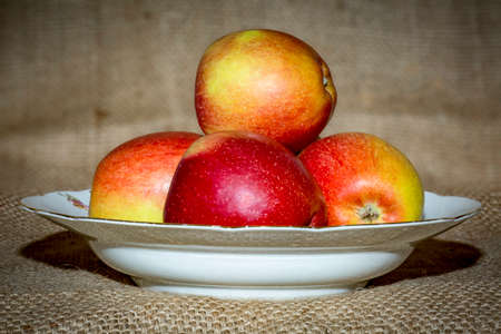 Apples on fruit plate with backgroundの写真素材