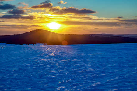 Snow landscape with sunsetの写真素材