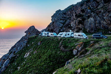 Mobile homes by the sea at sunsetの写真素材