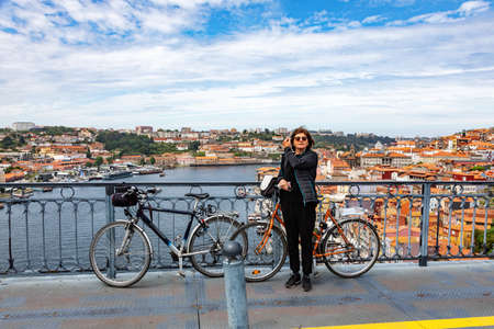 Woman with bicycle in Porto, Portugalの写真素材
