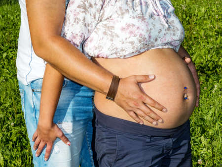 Man hugs pregnant womanの写真素材