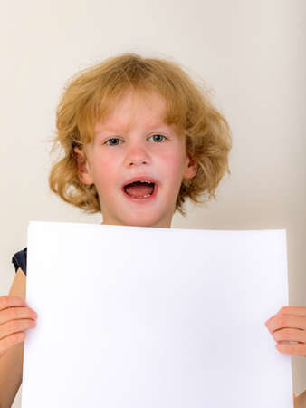 Child holds blank piece of paperの写真素材