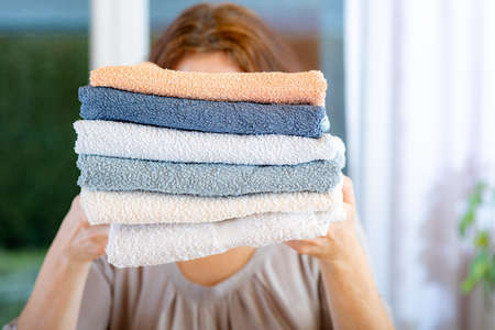 Woman carries towels