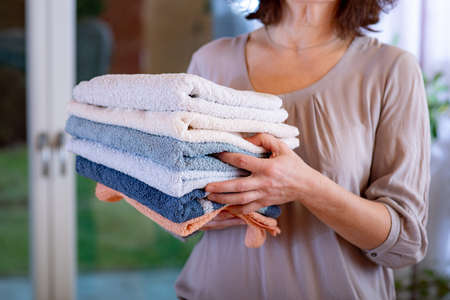 Woman carries towelsの写真素材