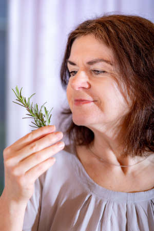 Woman with rosemary branchの写真素材