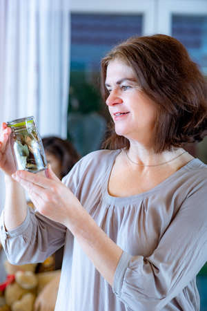 Woman with glass of spicesの写真素材