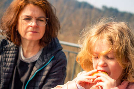 Woman with child picnic on castle Scharfenstein