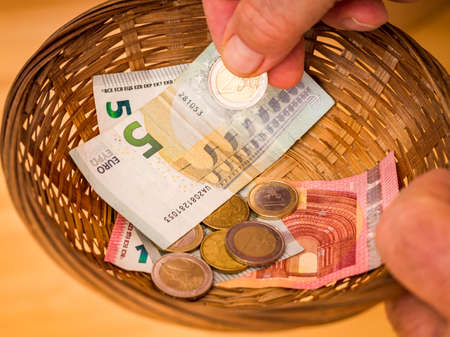 Donate basket with bills and coinsの写真素材