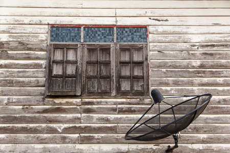 satellite dish at old wall home near windowsの写真素材