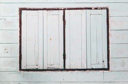 old windows on block wallの写真素材