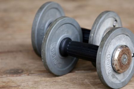 two dumbbells lying on the wooden groundの写真素材