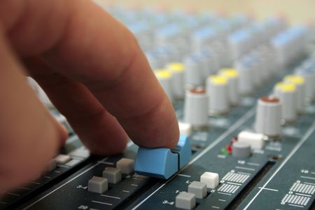 hand of sound engineer on the mixer