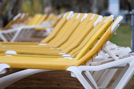 yellow chaise longues on the sand beach by the hotelの写真素材