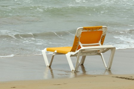 yellow chaise longue in water
