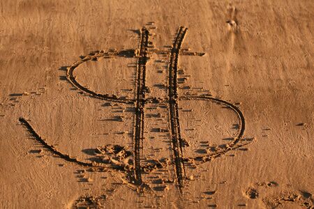 Sand writing on the beach - dollar sign.の写真素材