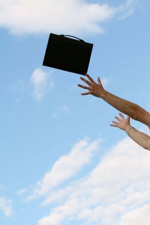 man throwing a document folder in the airの写真素材