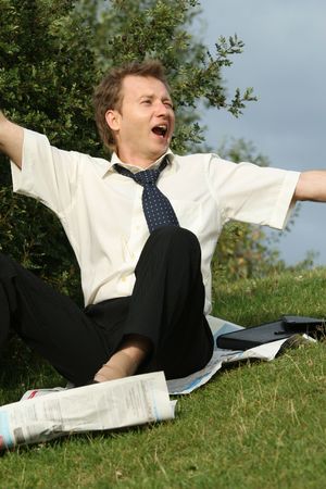 drunken businessman woke up in a city parkの写真素材