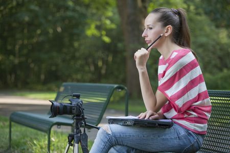 Female Photographer working with laptop and cameraの写真素材