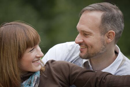 portrait of happy couple relaxing in a park
