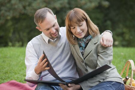 happy couple with photo album by picnicの写真素材