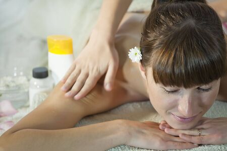 woman relaxing in wellness salon and gets healthy massageの写真素材