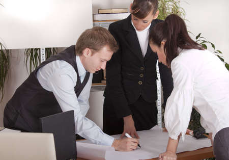 man and two women discussing about business plan in the office