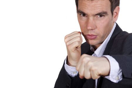 tired businessman punching on a white backgroundの写真素材