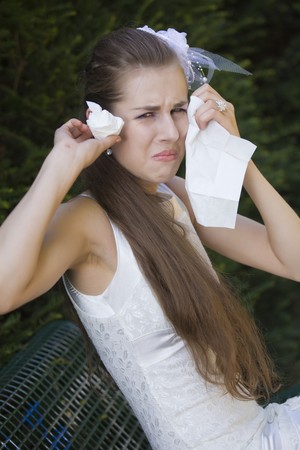 disappointed bride crying on the benchの写真素材