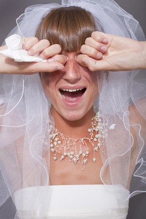 portrait of crying bride over grey backgroundの写真素材