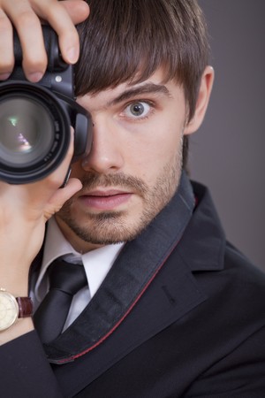 male photographer in business suit taking a pictureの写真素材