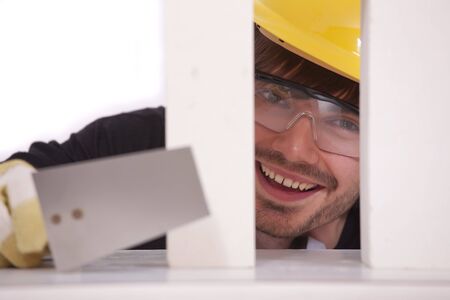 happy bricklayer with spade and white brick stonesの写真素材