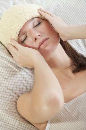 sick woman lying with fever in bedの写真素材