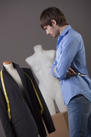 young male tailor working on business suit の写真素材