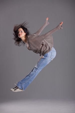 female hip hop dancer jumping in the airの写真素材