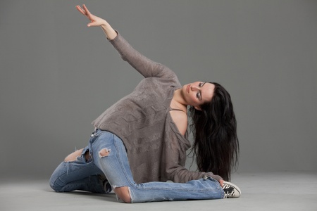 female dancer performing on the ground in studioの写真素材