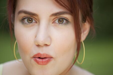 close-up portrait of surprised young woman, face expressionの写真素材