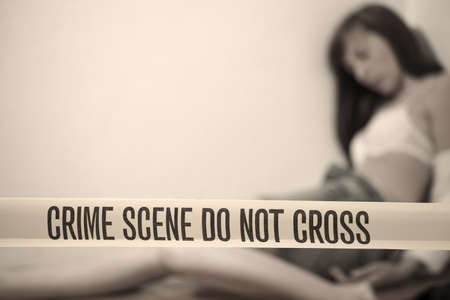 crime scene - abused woman playing dead on the groundの写真素材