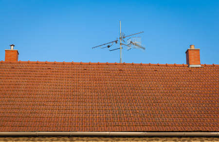 roof house with two smokestacks and antennaeの写真素材