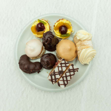 mini cakes on a white plate on the festive table setting to celebrate