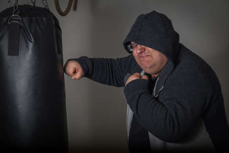 Fat man trains box in gymの写真素材