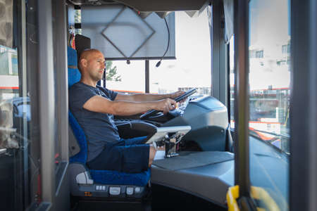The young men ride a bus, picking up the travelerの写真素材