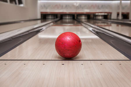 red bowling ball on the track in the bowling centerの写真素材