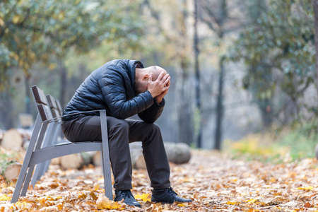 Autumn sadness and depression in the park on the benchの写真素材