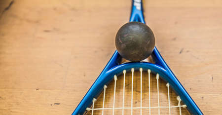 squash ball on court with squash racket ready to play new game