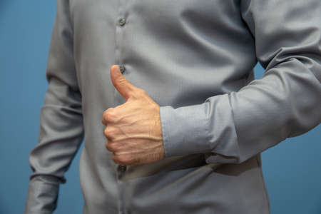 male hands with raised finger up. Confirmation of consent and expression of successの写真素材