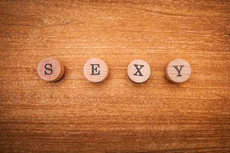 inscription sexy composed of wooden letters on a wooden background. Indicates courage, beauty, mysteryの写真素材