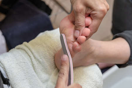 woman on pedicure and foot massage. Body care and relaxation for a healthy lifestyleの写真素材