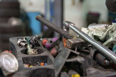 Repair and check car in repair shop. An experienced technician repairs the faulty part of the car. I change tiresの写真素材